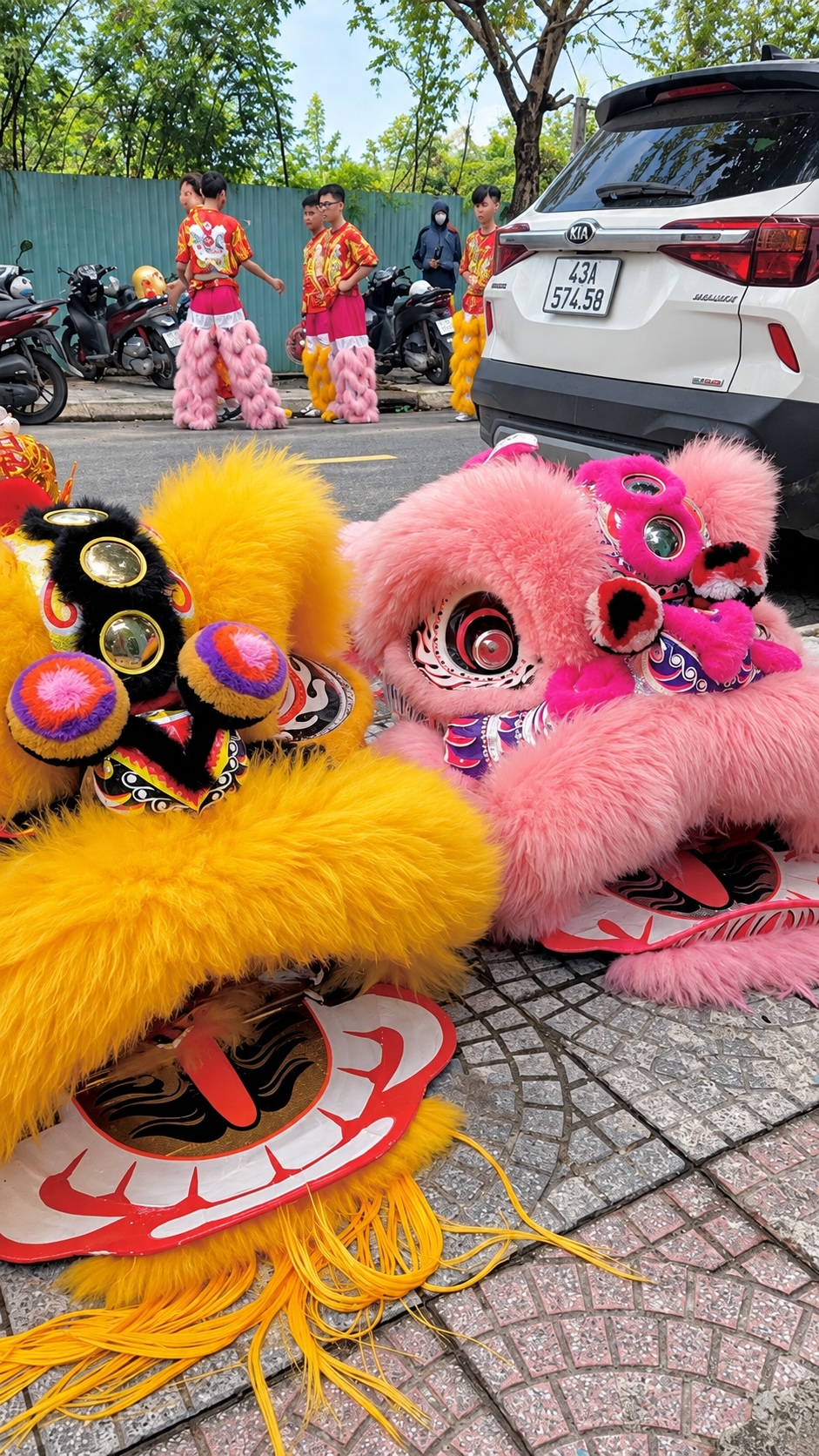Lion dancers performing for guests in a festive garden setting